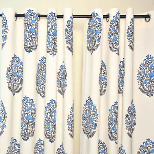 Jaipuri cotton curtain with blue floral boota design hanging on black grommet rod