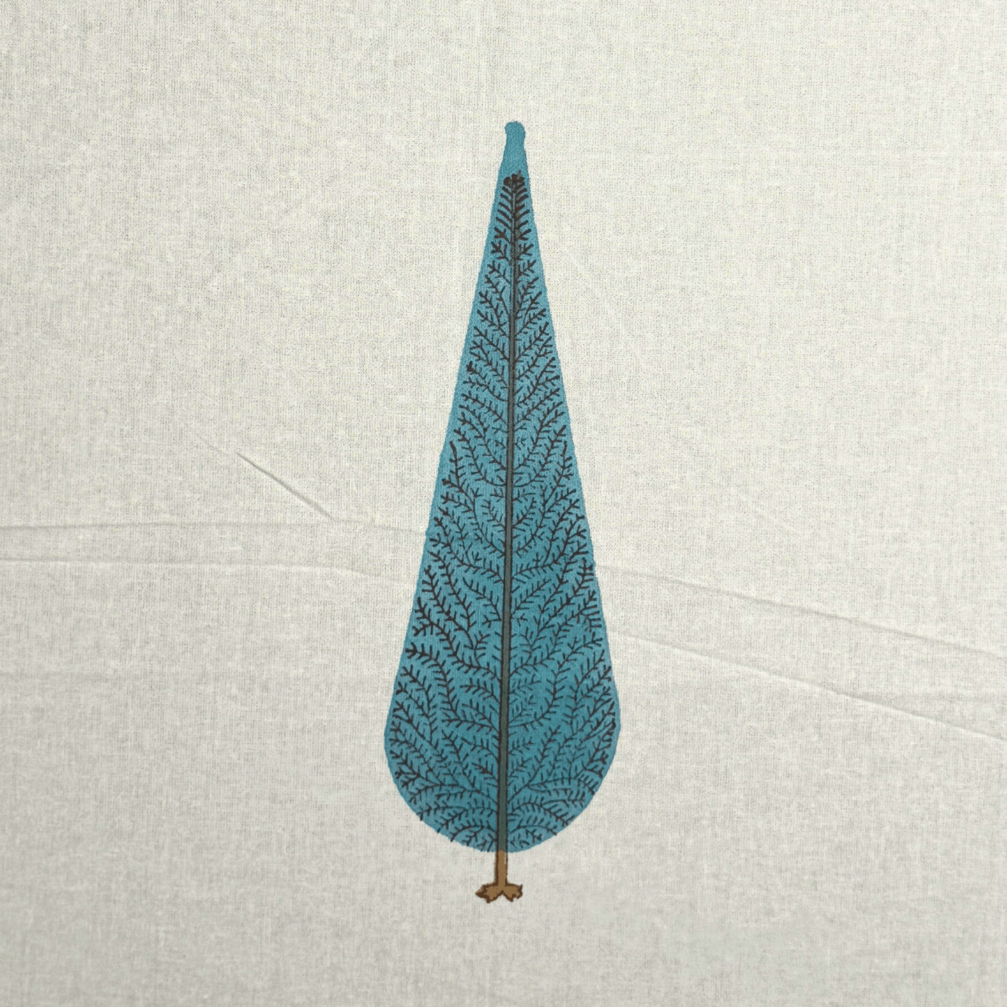 Close-up of handprinted blue cypress tree motif on off-white cotton curtain