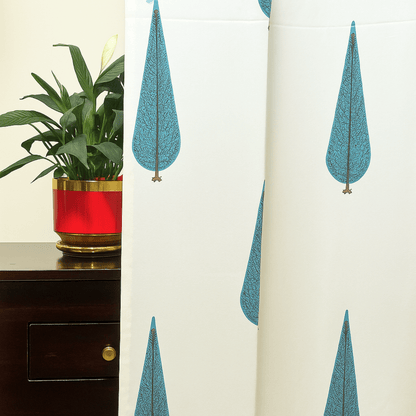 Cotton curtain with blue cypress tree block print next to a red planter