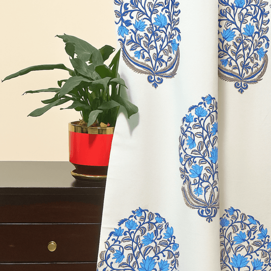 Block printed cotton curtain with blue Mughal boota motifs next to a red planter