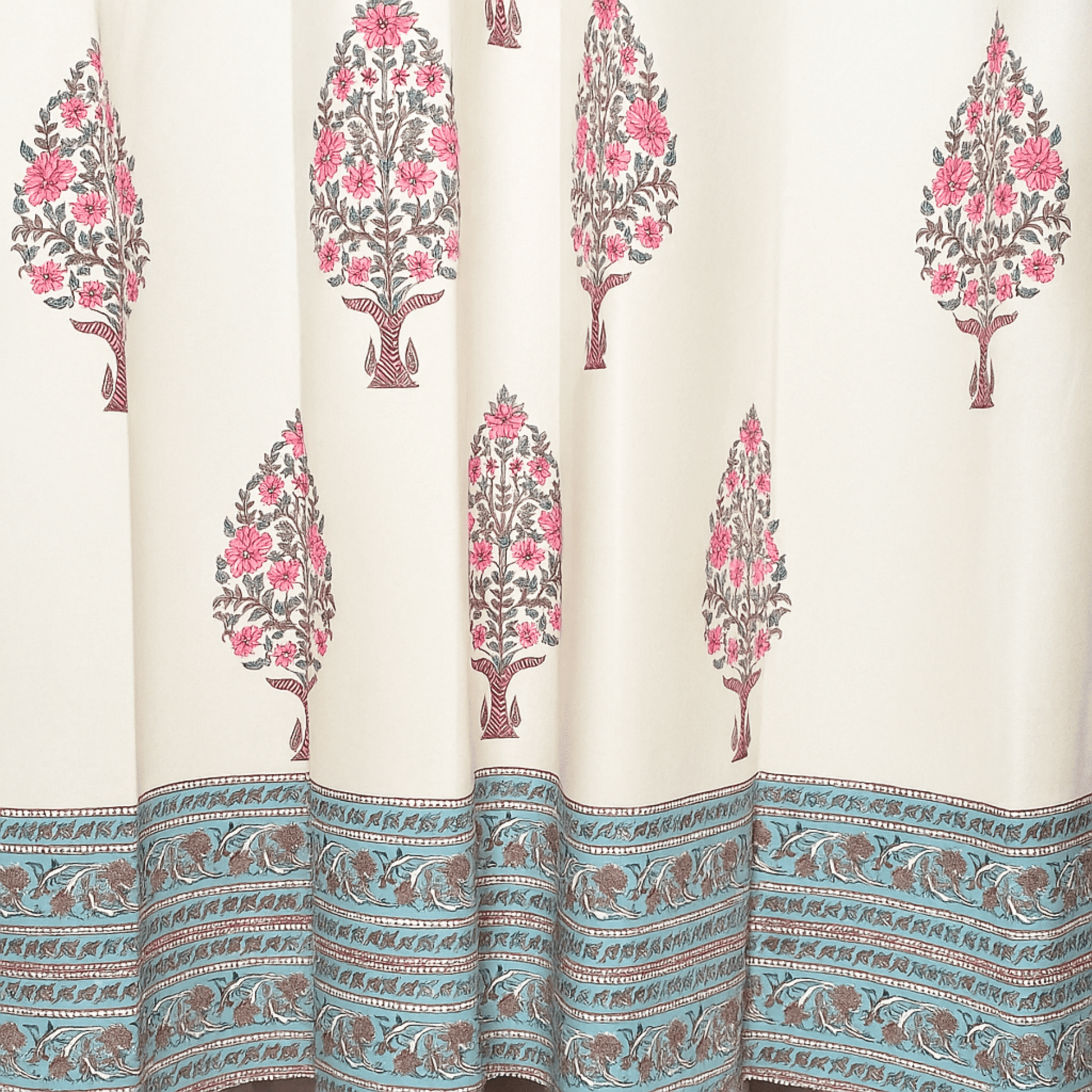 Handprinted curtain with pink floral tree motifs and blue printed border at the hem

