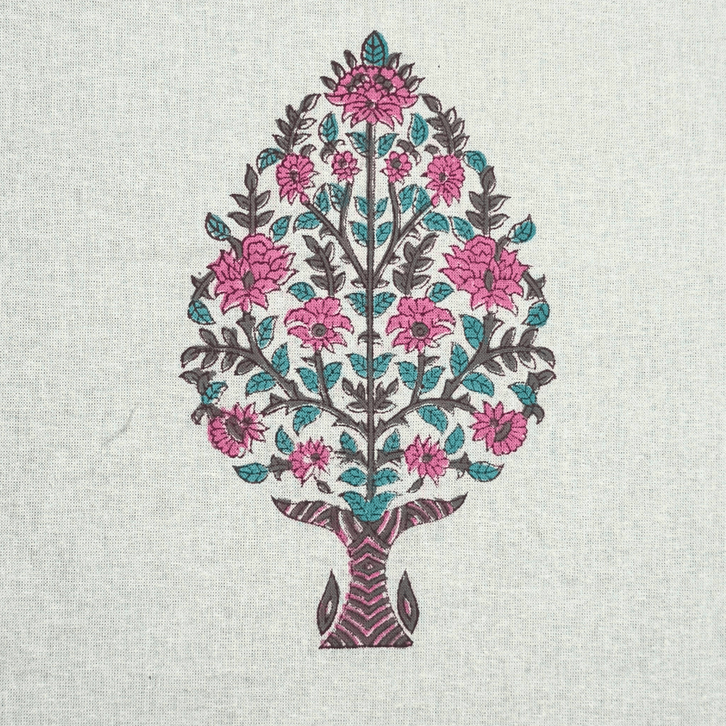 Close-up of traditional pink floral tree block print on white cotton fabric

