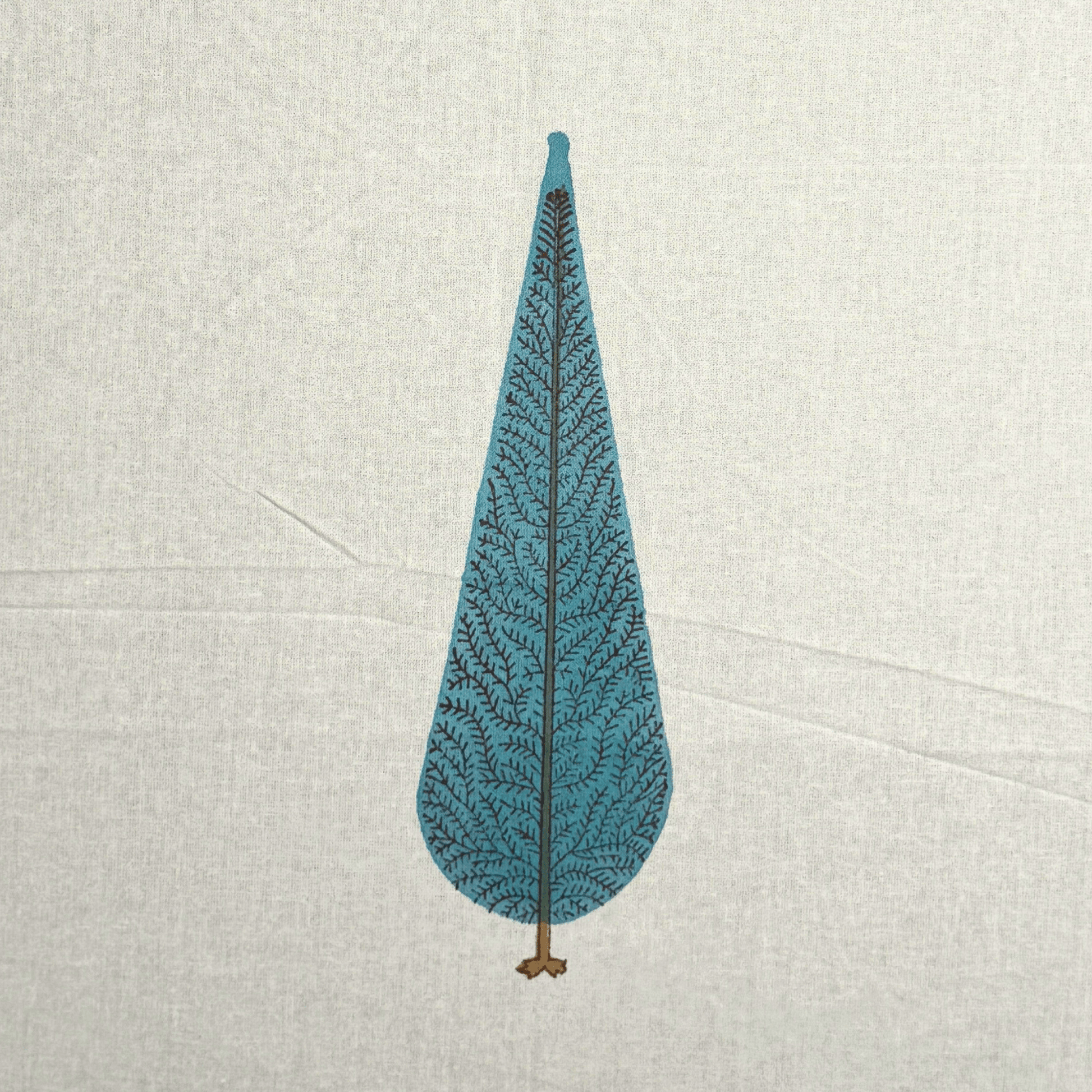 Close-up of handprinted blue cypress tree motif on off-white cotton curtain